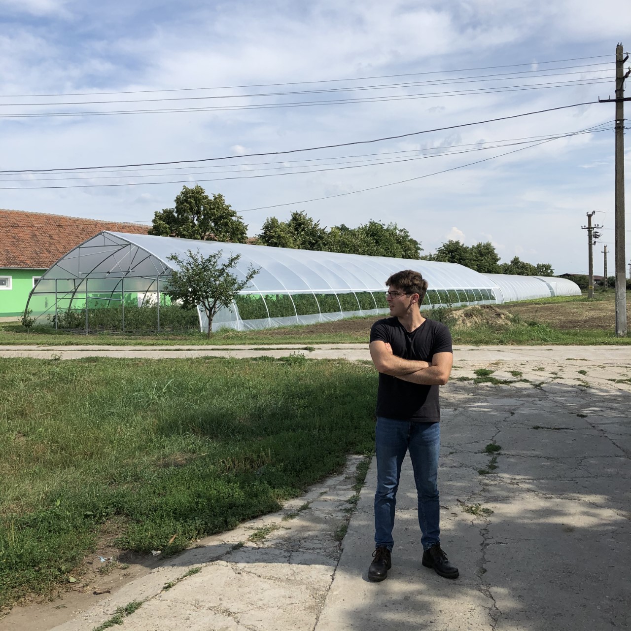 Man in front of green house