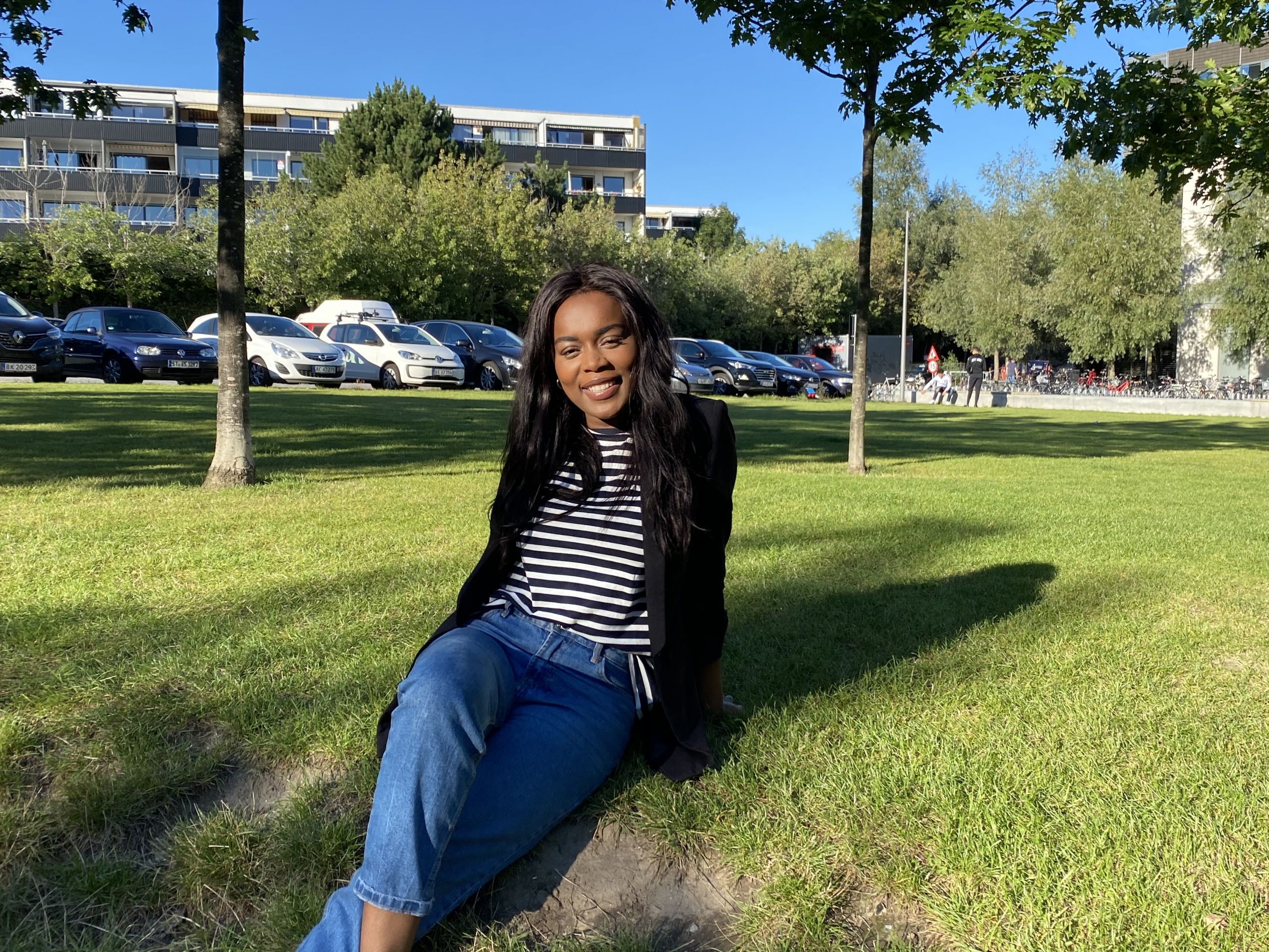 young woman sitting on grass