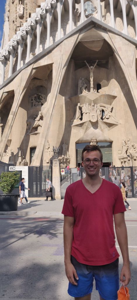 young man in front of La Sagrada familia in Barcelona