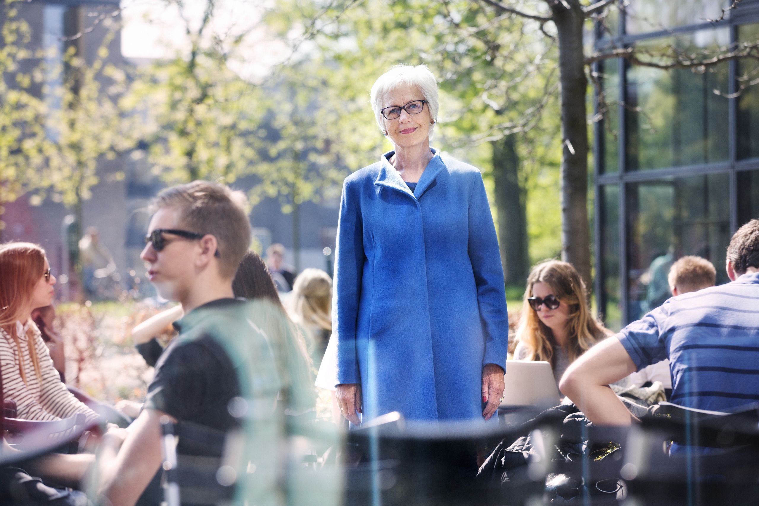 Lady in blue jacket stading outside