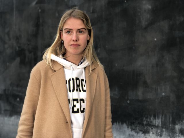 Female student in brown coat