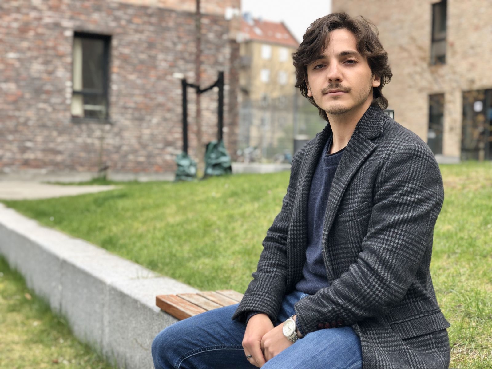 Man sitting on bench outside