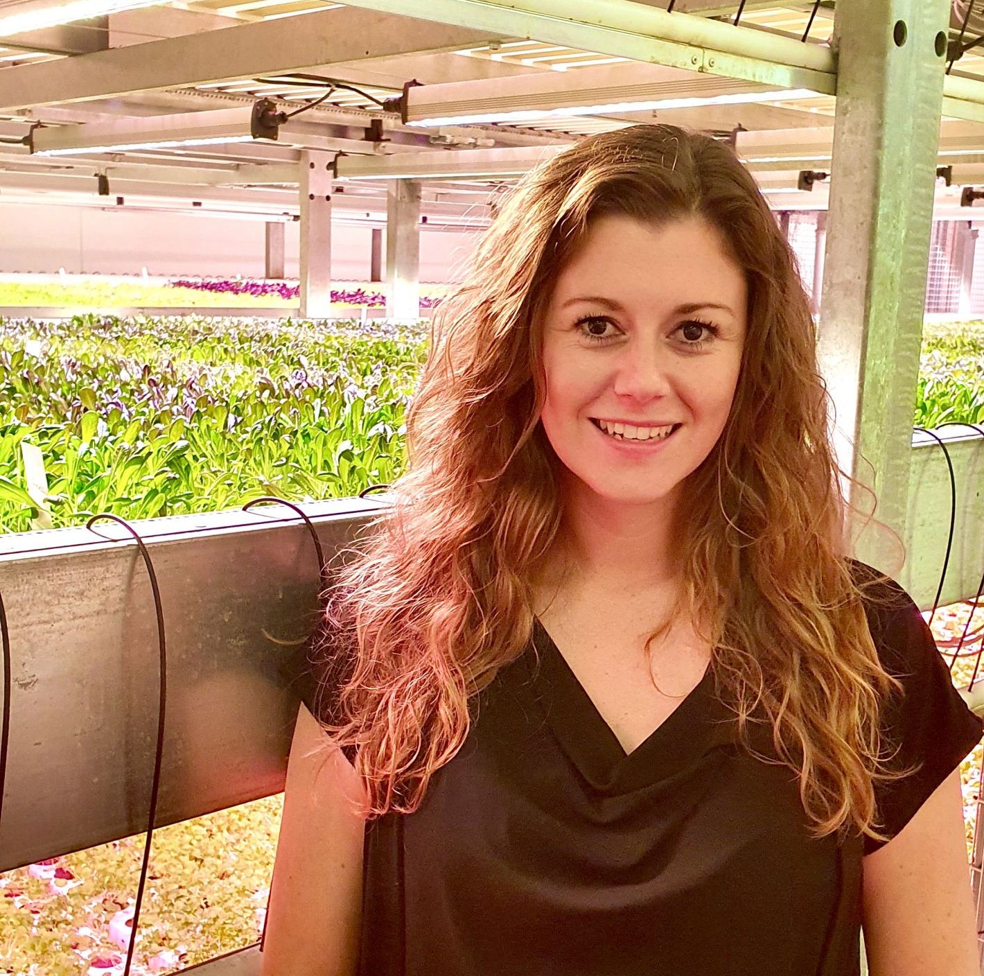 Woman standing in greenhouse