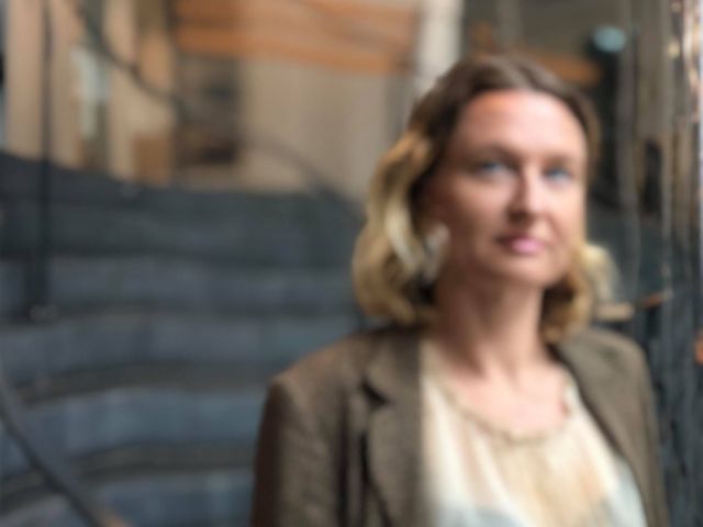 Woman looking in mirror out of focus