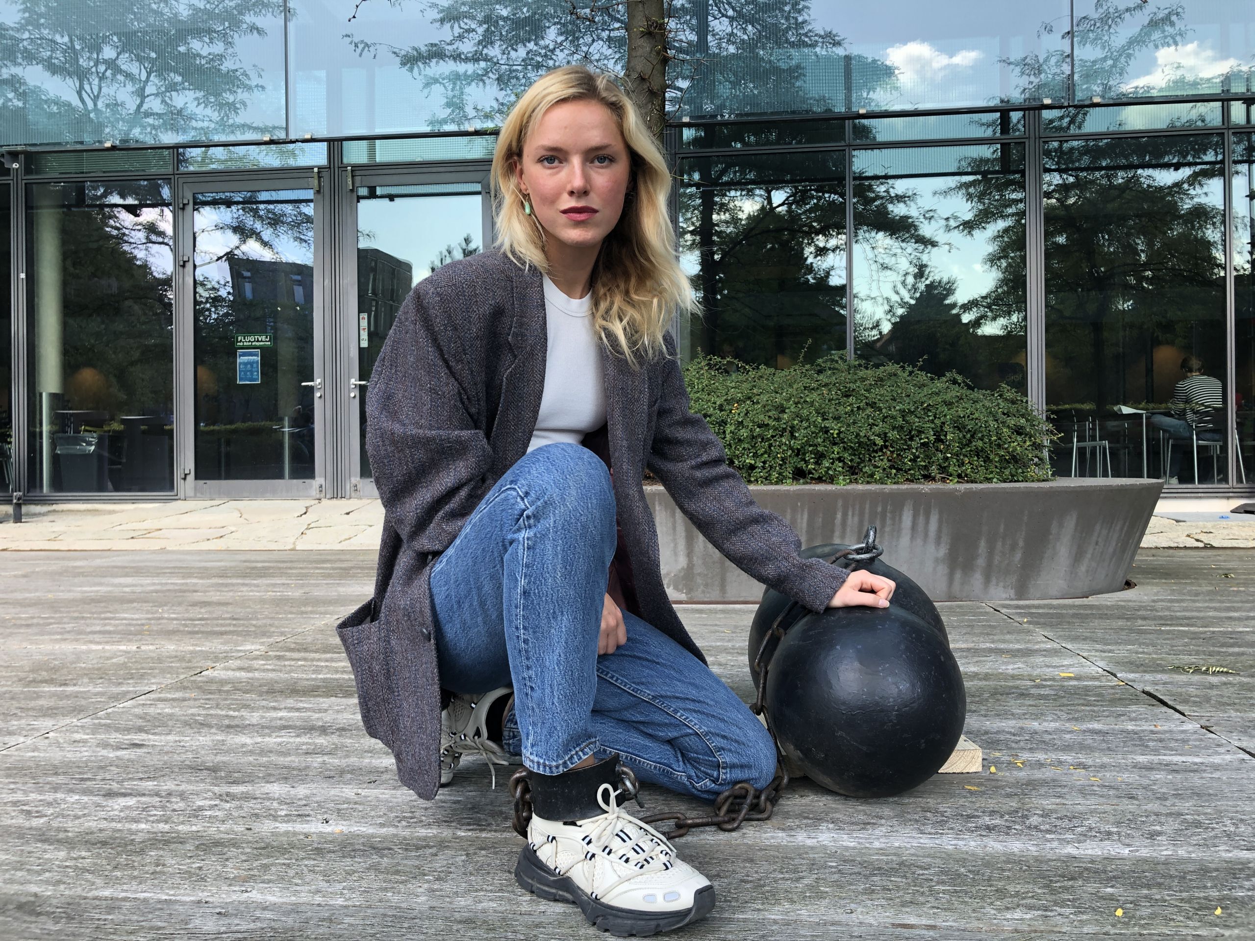 woman locked to iron sculpture