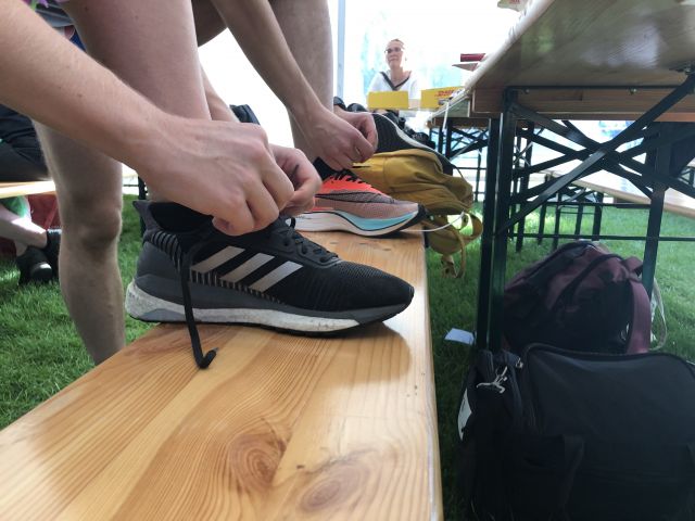 Two runners tying shoes