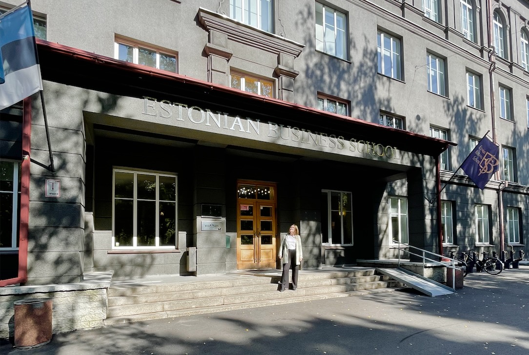 young woman in front of Business school in Tallinn.