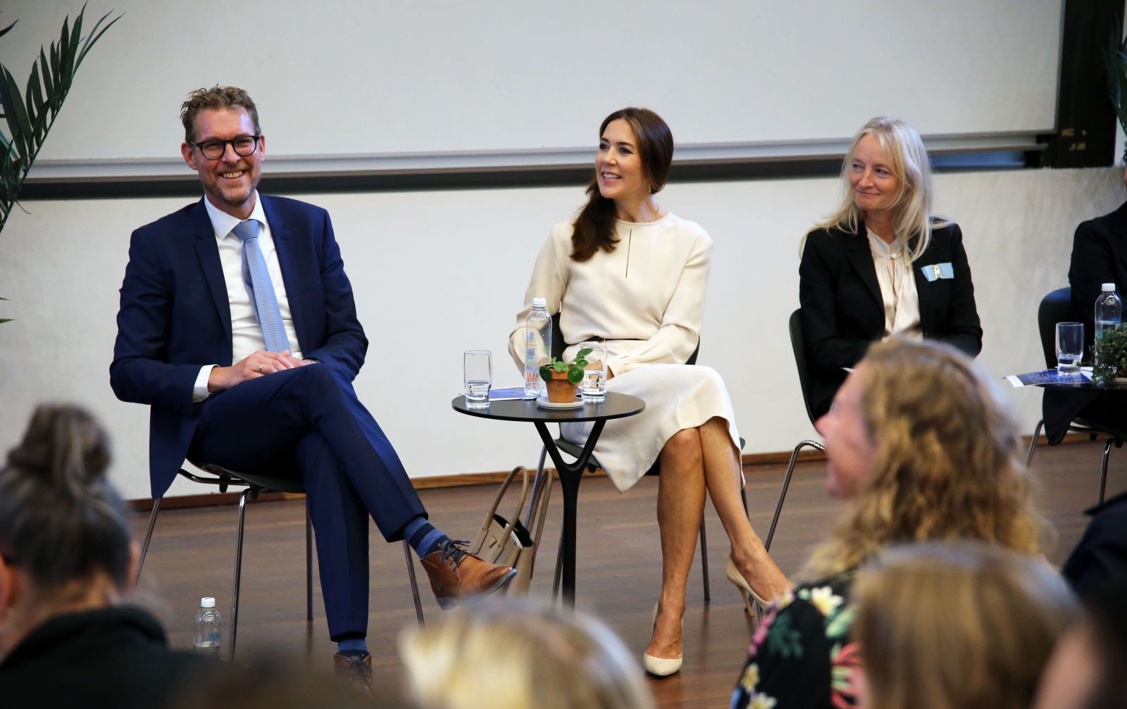 Man and woman sitting at a conference