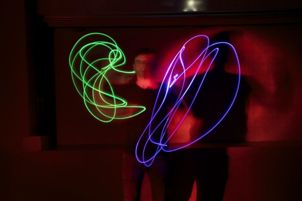 Man juggling with neon lights