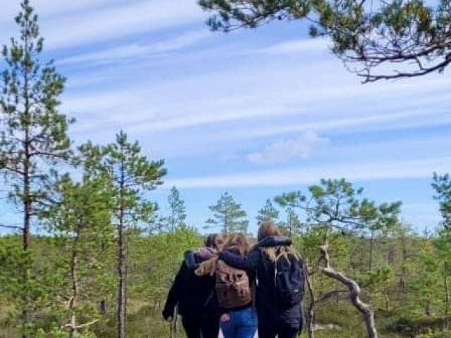 three friends walking by lake