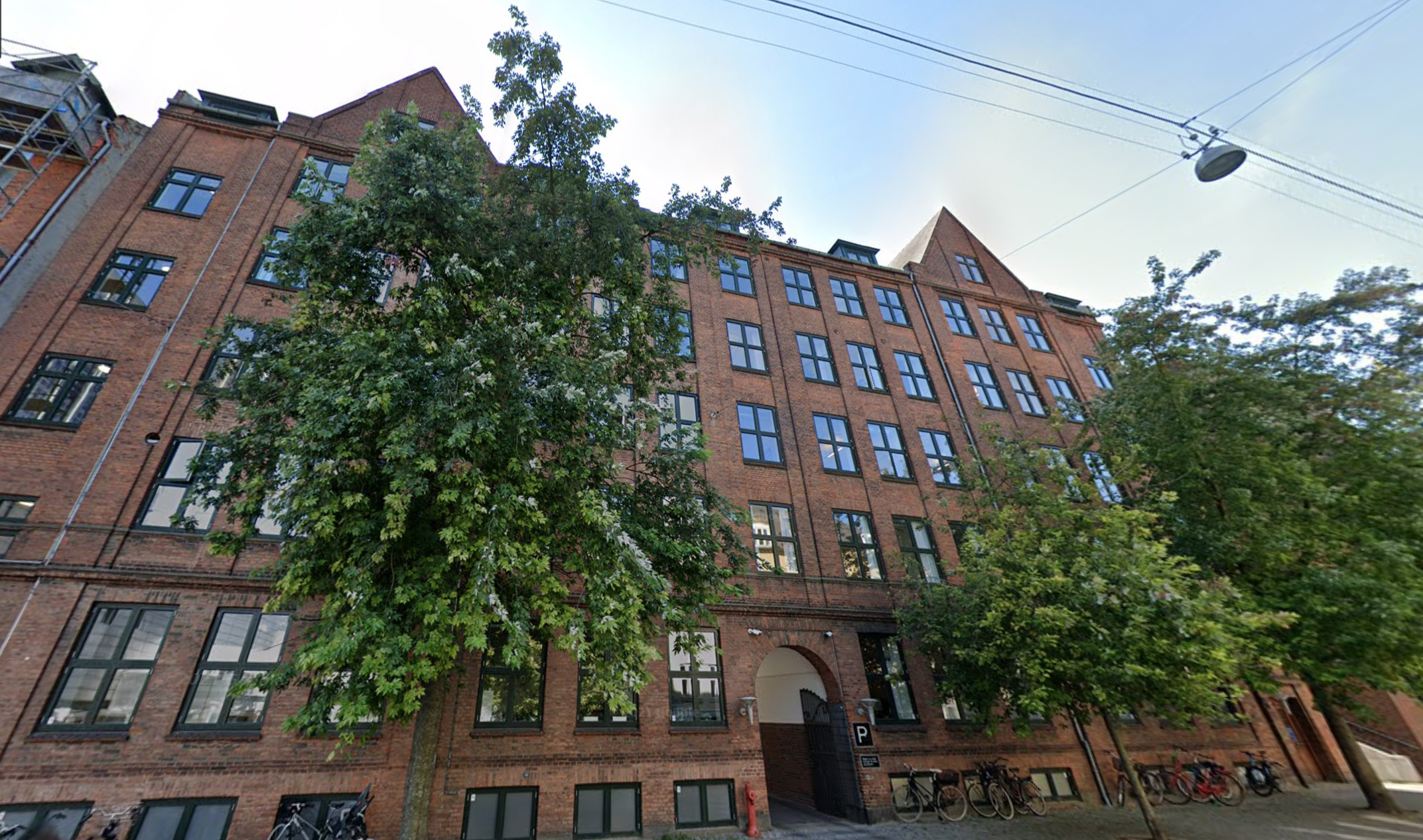 Red brick building with trees in front